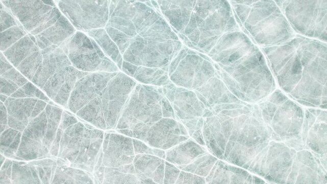 Drone view of half frozen lake with ice on water, close up view of blue ice crack and bubbles in earl spring day, top view ice floating on lake, 4k real time footage travel concept.