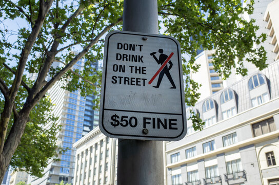 a public order sign mounted on a street pole in Melbourne's CBD, reading "Don't Drink on the Street &mdash; $50 Fine". Local council alcohol-free zone regulations enforced in Australia