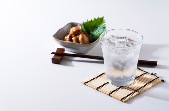 Shochu and nibbles on a white background with a copy space.