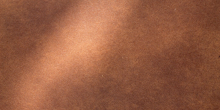 Brown suede leather background texture with soft light effect
