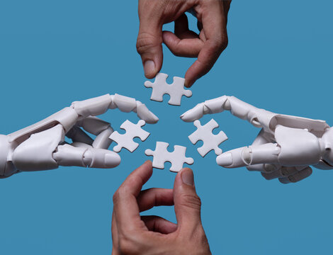 AI robots and human joining jigsaw puzzle for teamwork and solution concept.