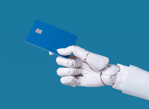 Robotic hand holding blank blue credit card on blue background.