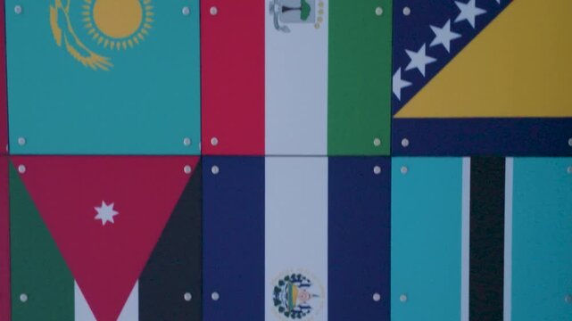 International flags scroll vertically across screen, showcasing multiple country banners in colorful grid. Ideal for global news, diplomacy, travel, and multicultural themes.