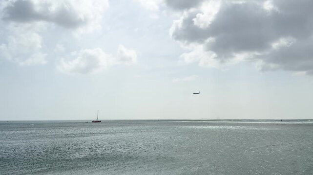 Static wide shot of a vast open Caribbean ocean stretching to the horizon under a cloudy overcast sky creating a calm and minimalist seascape. Shot on iPhone 17 Pro.