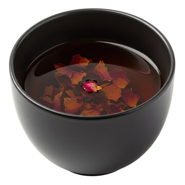Dark tea bowl with floating rose petals and bud in warm light isolated on white background
