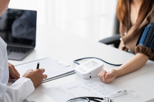Doctor checking  patient arterial blood pressure. Health care measuring blood pressure of patient