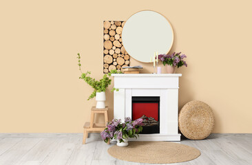 Obraz premium Interior of living room with fireplace, mirror and spring branches in vases