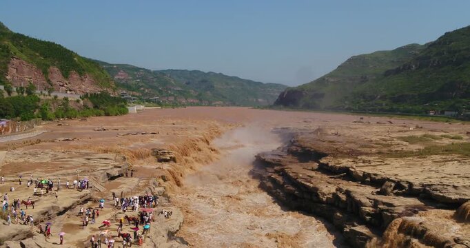 Tourists at Hukou Waterfall on the Yellow River in China in Hukou Waterfall, Yellow River, China