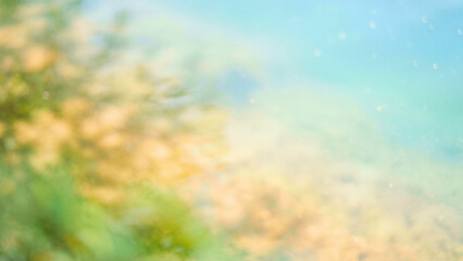 Fototapeta premium Dreamy green and golden bokeh lights creating a fresh outdoor atmosphere.
