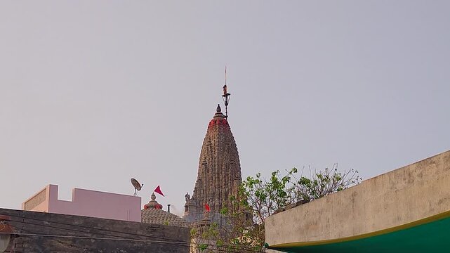 Rare footage of a man climbing Dwarkadhish temple shikhara spire during dhwaja changing ritual. Essential B-roll for Hindu pilgrimage docs, Krishna devotional films and sacred ceremony content.