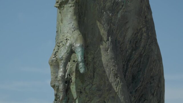 Closeup Bronze Left Hand Detail on Monument to the Mother of Immigrants Statue in Gijon Spain