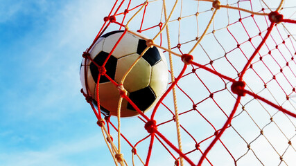 Low angle shot of football hitting target net celebrating championship victory with clean summer cloudless sky and copy space © pixfly
