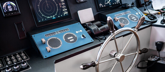 Digital dashboard with navigation monitor system, radar and VHF Radio in ship captain bridge or boat engine control room. Wheelhouse steering console on maritime transport. Nautical vessel technology © zephyr_p