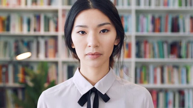 Serious, face and businesswoman with pride in library, knowledge and paralegal with job opportunity. Corporate, law assistant and Asian person with career growth, legal books and research for case