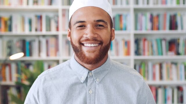 Face, Muslim man and smile with scholar in library for religious information or study. Confident, happy and Islamic person in bookstore for development or research of Arabic culture and language