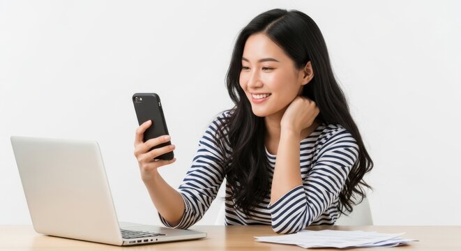 Woman taking selfie with smartphone at desk