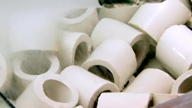 Observe pristine ceramic rings within powerful hydro filter. Water gracefully washes over circular media, diligently scrubbing pollutants from air. Continuous process of environmental renewal.