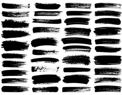 Collection of various thick and thin, black, textured brush strokes on a white background