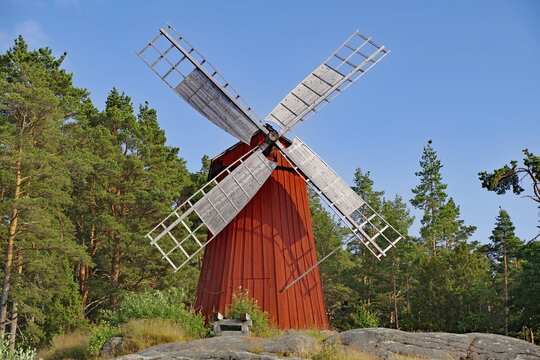 Small red wooden windmill at the edge of the forest, rocks, autonomous region, Sund, Aland Islands, Finland