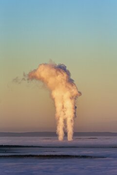 Two columns of steam rising from cloud cover, Grohnde nuclear power plant seen from K&ouml;terberg, sunset, L&uuml;gde, Weserbergland, North Rhine-Westphalia, Germany