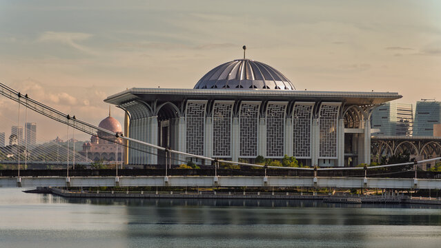 Tuanku Mizan Zainal Abidin Mosque, Putrajaya, Malaysia. Modern Islamic architecture with its dome, seen across Putrajaya Lake, with Putra Mosque and bridges in the background