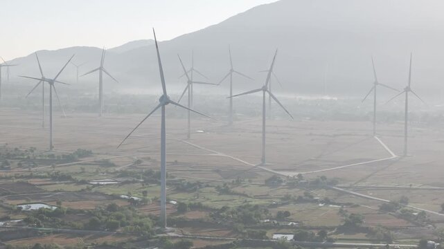 Aerial view of wind turbines and solar farms near the Cam Lam&ndash;Vinh Hao Expressway in Thuan Bac Commune, Khanh Hoa, Vietnam, showcasing large-scale renewable energy infrastructure.