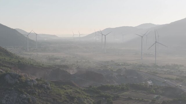 Aerial view of wind turbines and solar farms near the Cam Lam&ndash;Vinh Hao Expressway in Thuan Bac Commune, Khanh Hoa, Vietnam, showcasing large-scale renewable energy infrastructure.