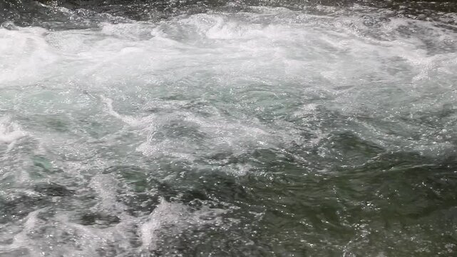 Detail of water flowing in a stream, fresh and natural landscape, video with audio in background