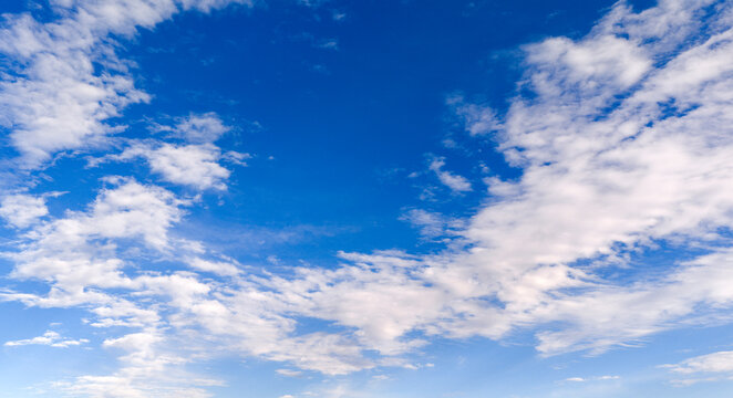Sky texture with blue clouds. Soft sky white cloud texture backdrop. Bright daylight sky wallpaper. Sky cloudscape pattern skyscape.