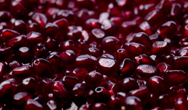 Pomegranate seeds macro texture background. Red ruby pomegranate arils close up texture. Pomegranate arils texture. Pomegranate seeds detail for texture.