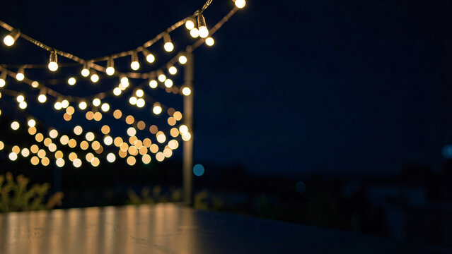 Festive string lights bokeh illuminating a dark evening setting