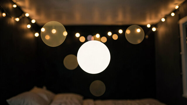 Dusk golden string lights creating intimate bokeh over plush bedding