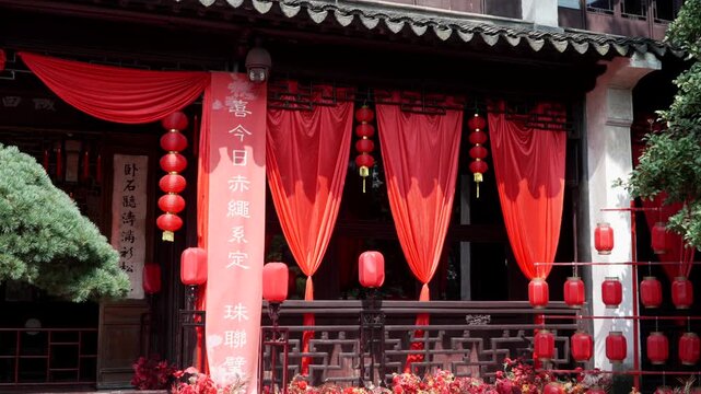 Traditional Chinese Building with Red Lanterns and Flowing Red Curtains