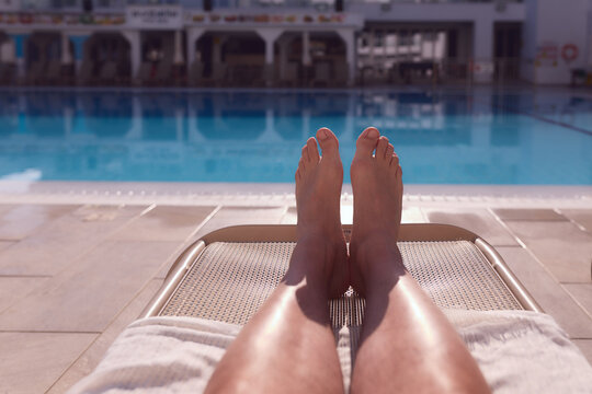 Man enjoying the hot summer at swimming-pool.