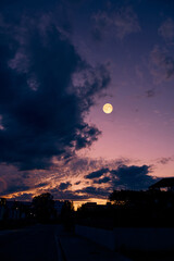 Obraz premium Full Moon with urban silhouettes.
