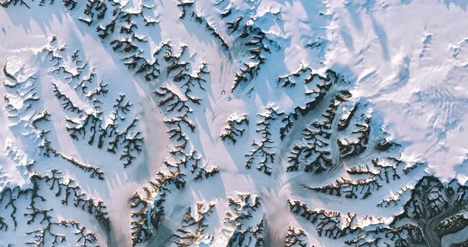 Bird's eye view on nunataks, glaciers and snow. Camera is zooming out. Animation based on image by NASA