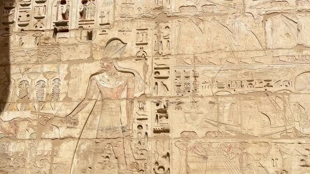 Beautiful bas-reliefs and ancient hieroglyphs from the mortuary temple of Ramesses III at Medinet Habu, Luxor, Egypt