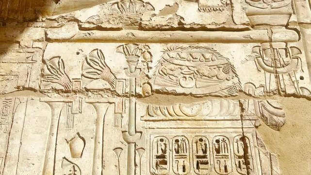 Beautiful bas-reliefs and ancient hieroglyphs from the mortuary temple of Ramesses III at Medinet Habu, Luxor, Egypt