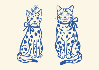 Two cute cartoon cats with blue spots and bows Vector © Jrdesign0