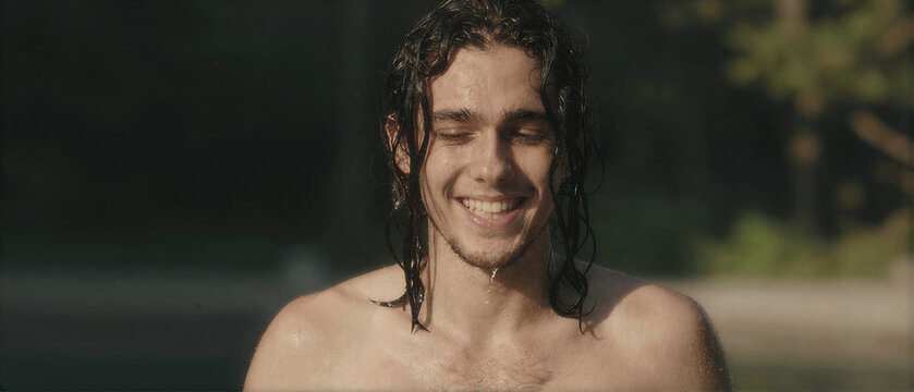Smiling Man Under Water Splash