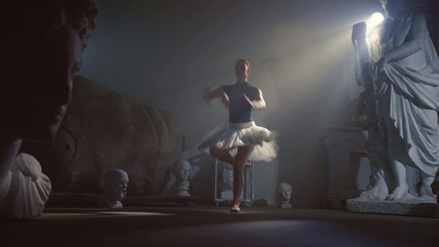 Talented ballerina performing jump in dark museum hall, female grace and beauty. Beautiful woman in tutu and pointe shoes dancing alone, performing ballet choreography, contemporary art performance