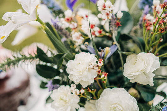 Elegant floral arrangement featuring white ranunculus and lavender