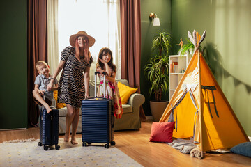 Family preparing for summer vacation with suitcases and teepee tent © MexChriss