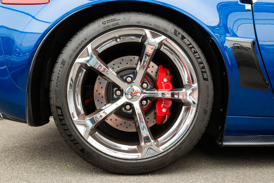 Lucerne, Switzerland, May 30, 2026. Chrome wheel rim and red brake caliper on a blue Chevrolet Corvette C6 ZR1 supercar.