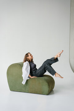 Happy Woman Sitting Green Sofa Legs Up