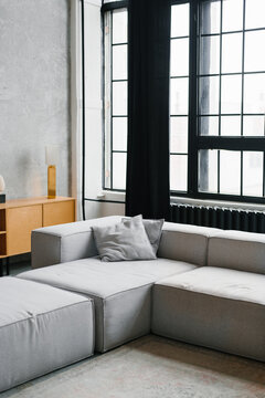 Modern Minimalist Living Room with Grey Sofa and Large Window