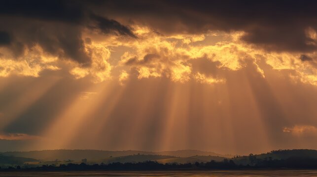 Dawn sky with radiant sunrays breaking through clouds over open fields, expressing hope for the day ahead
