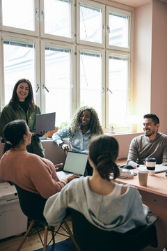 Group of tech experts talking with each other in business meeting at startup office