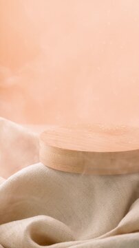 Wooden podium with distinct water droplets on beige linen fabric with steam smoke vapor from diffuser on warm background for skincare product display vertical seamless loop