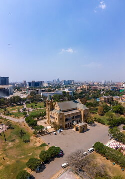 Aerial view of Frere Hall featuring its Venetian Gothic architecture and yellow limestone walls surrounded by lush gardens in Karachi, Sindh, Pakistan.